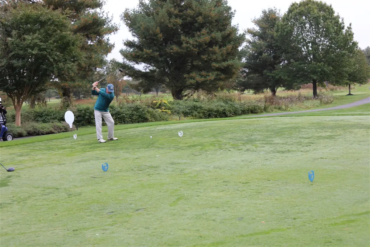 Man swinging at golf ball