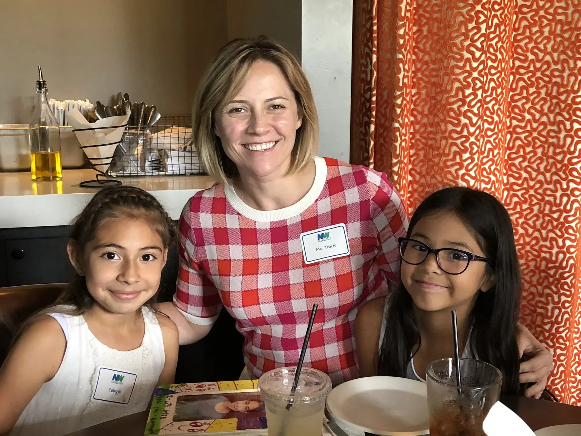 adult and 2 children smiling
