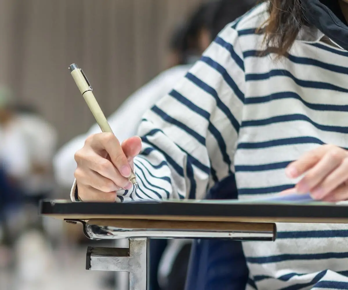 person writing at desk