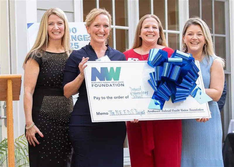 Foundation employees with big check