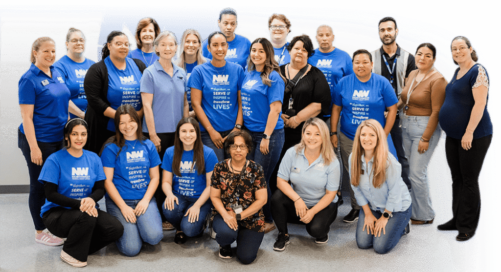 Group of corporate sponsors and foundation staff smiling together at community service event