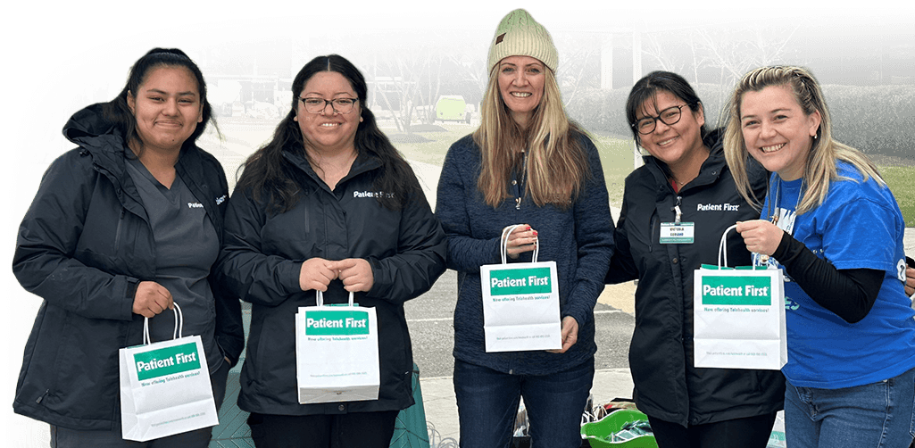 NWFCU Foundation employees holding Patient First swag bags